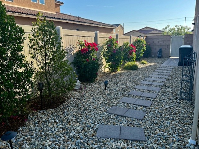 28340 Memory Lane Winchester, CA 92596 - Photo 35 of 39 a view of a house with a flower garden
