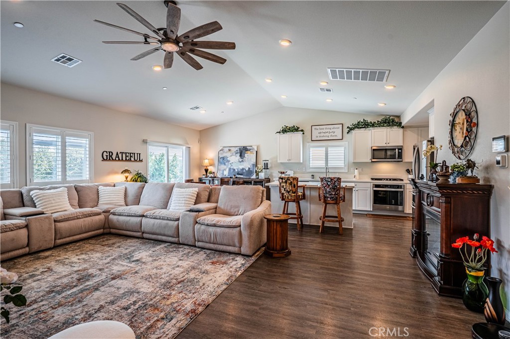 28340 Memory Lane Winchester, CA 92596 - Photo 7 of 39 a living room with furniture kitchen view and a wooden floor