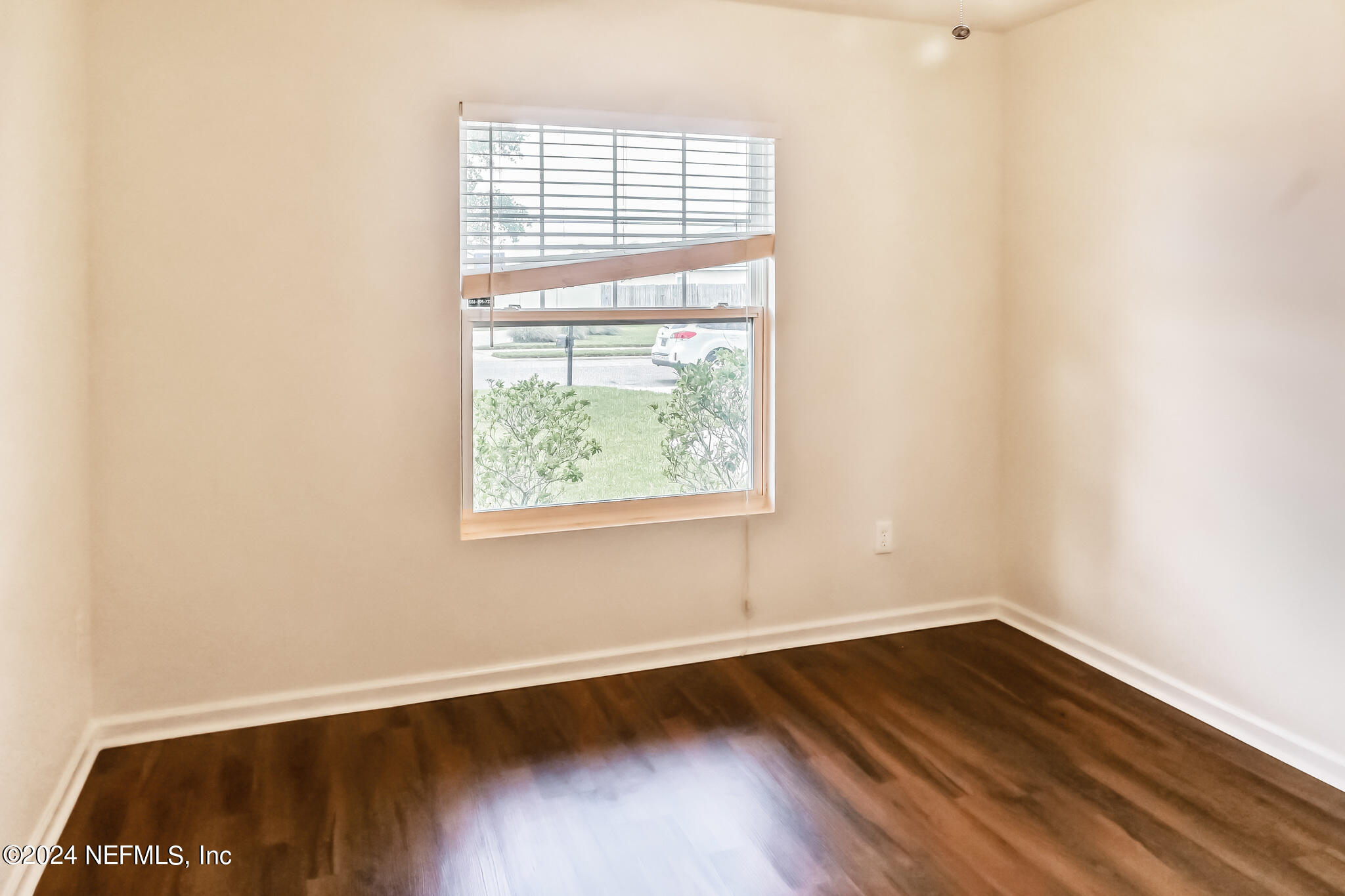 15234 Bareback Drive Jacksonville, FL 32234 - Photo 17 of 21 an empty room with wooden floor and windows