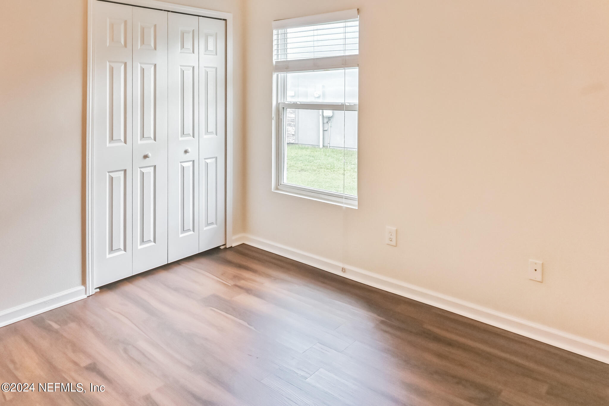 15234 Bareback Drive Jacksonville, FL 32234 - Photo 18 of 21 an empty room with wooden floor and windows