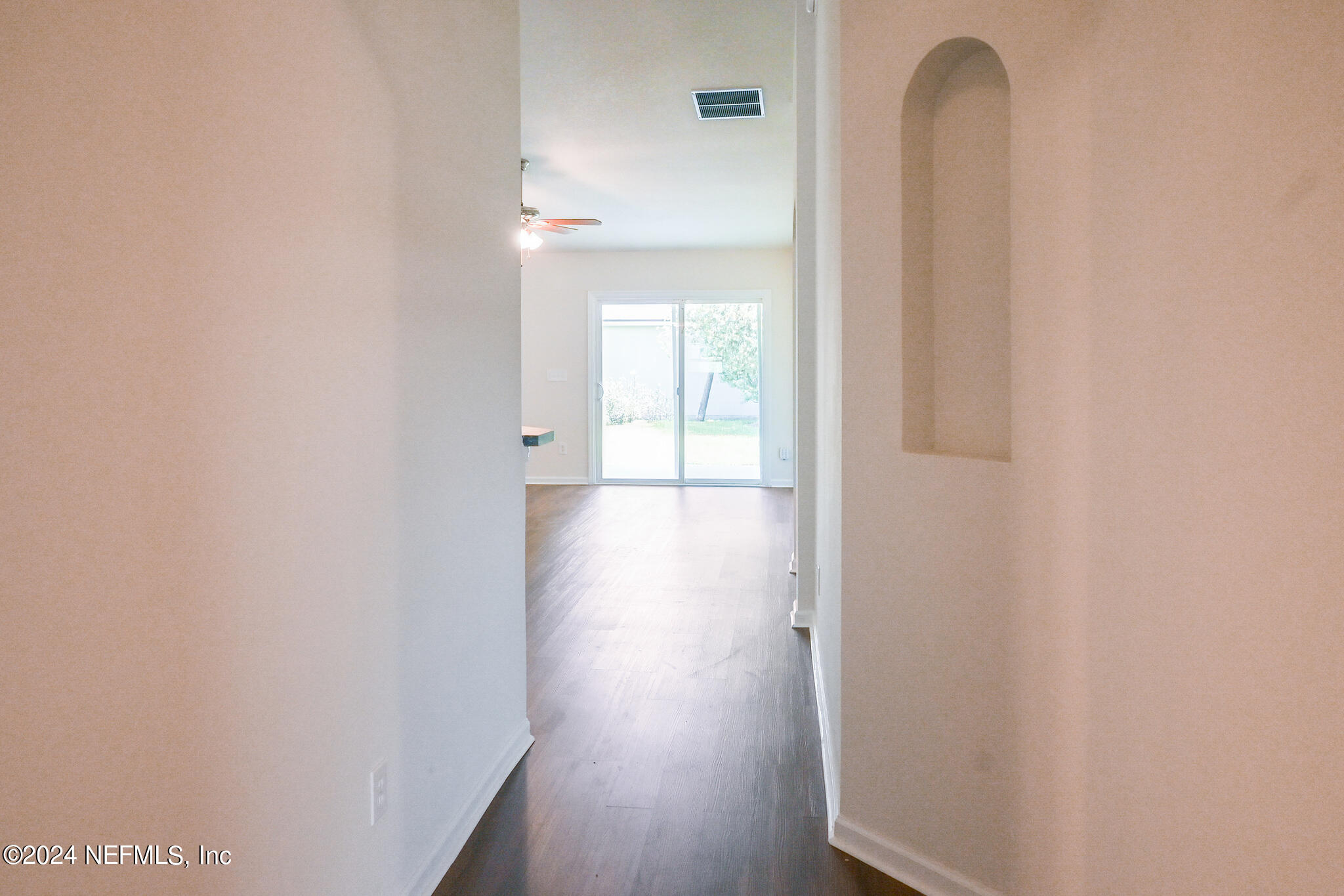 15234 Bareback Drive Jacksonville, FL 32234 - Photo 3 of 21 a view of a hallway with wooden floor