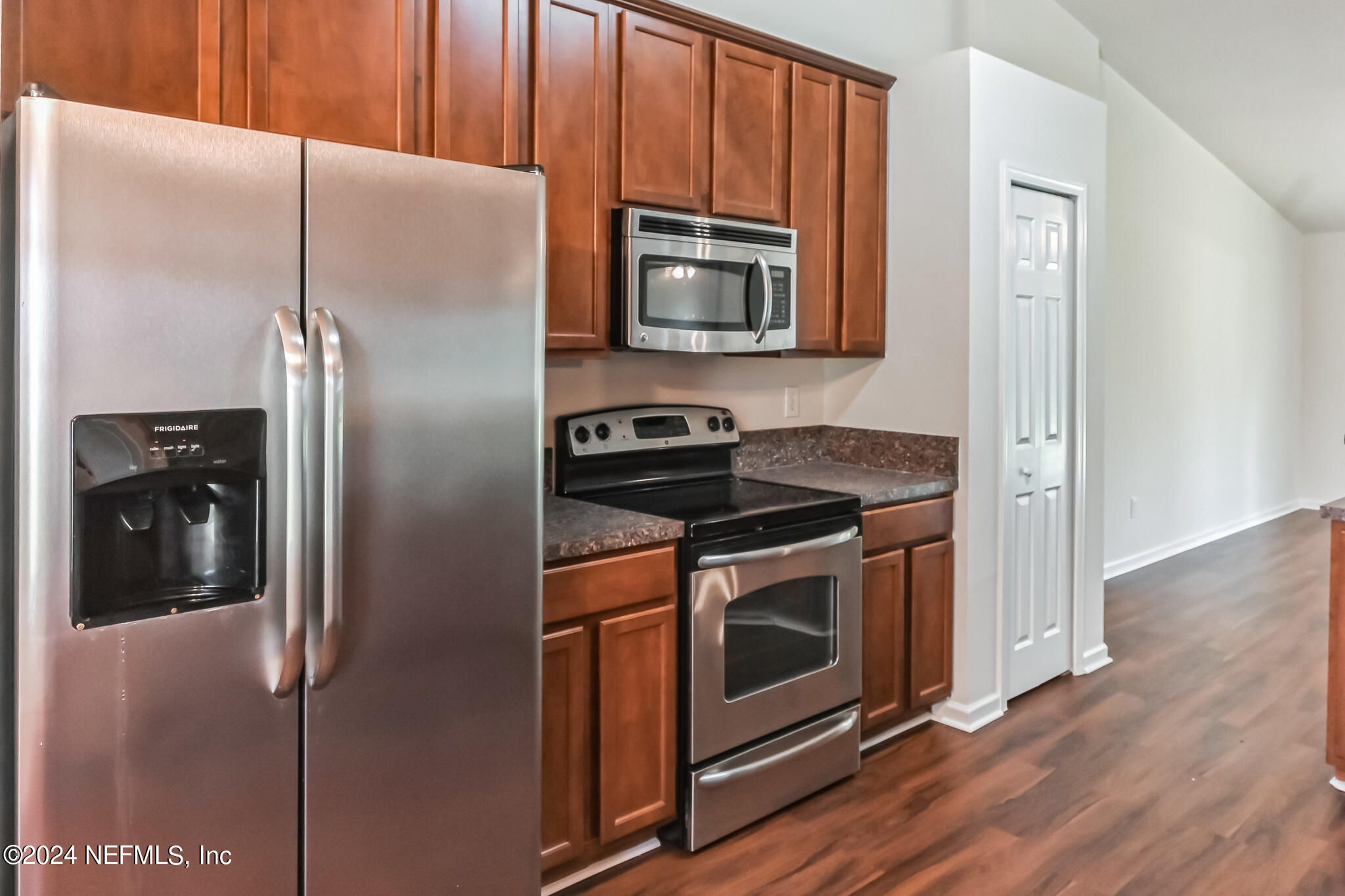 15234 Bareback Drive Jacksonville, FL 32234 - Photo 8 of 21 a kitchen with stainless steel appliances granite countertop a refrigerator and a microwave