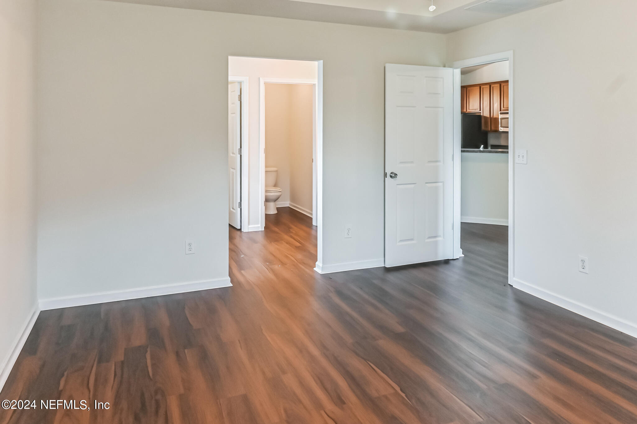 15234 Bareback Drive Jacksonville, FL 32234 - Photo 9 of 21 an empty room with wooden floor and closet