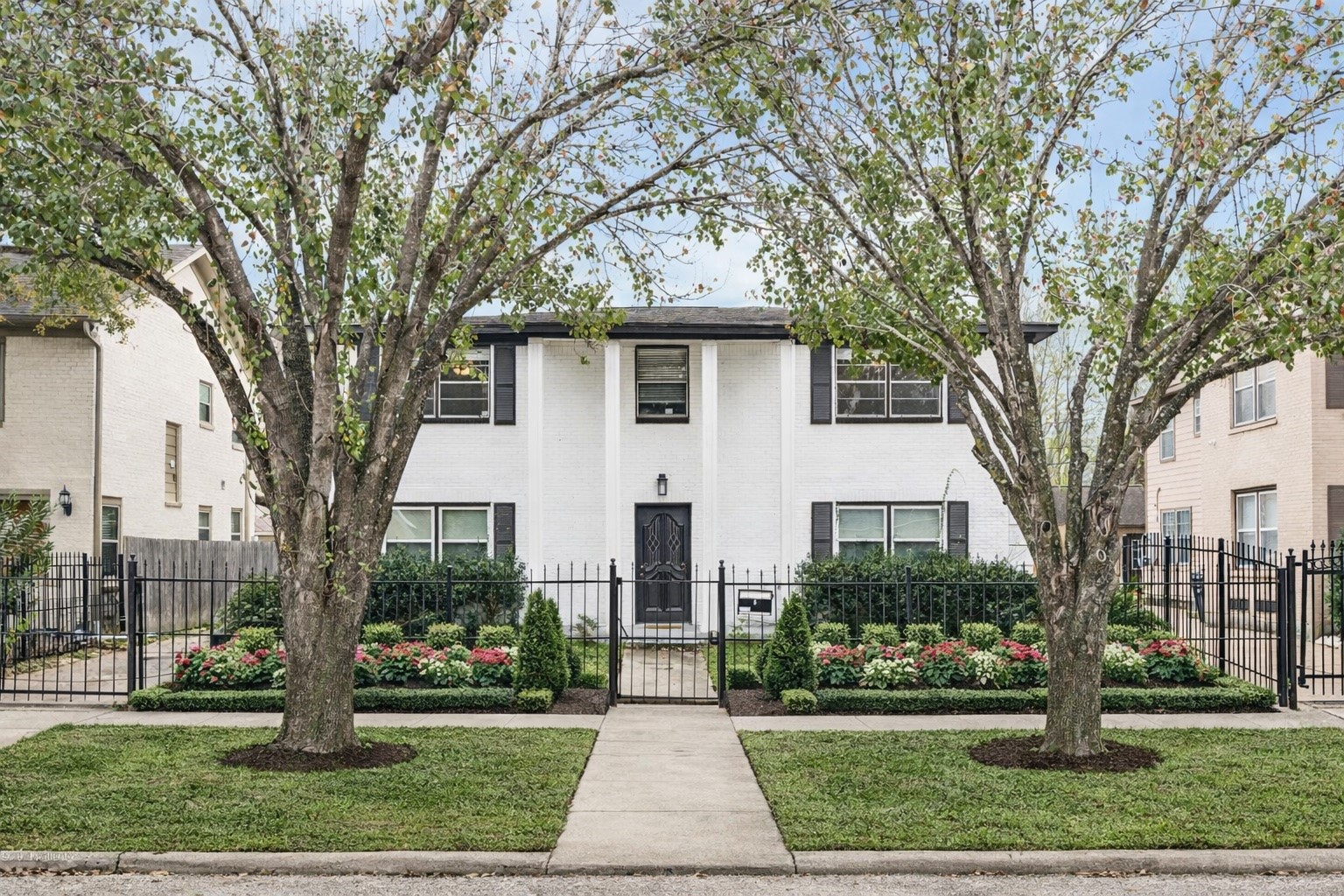 2614 Cleburne Street Houston, TX 77004 - Photo 2 of 22 Symmetry meets sophisticated curb appeal. This virtually enhanced preview highlights the home’s crisp two-story facade and welcoming entry, framed by lush, visionary landscaping that commands attention from the street.