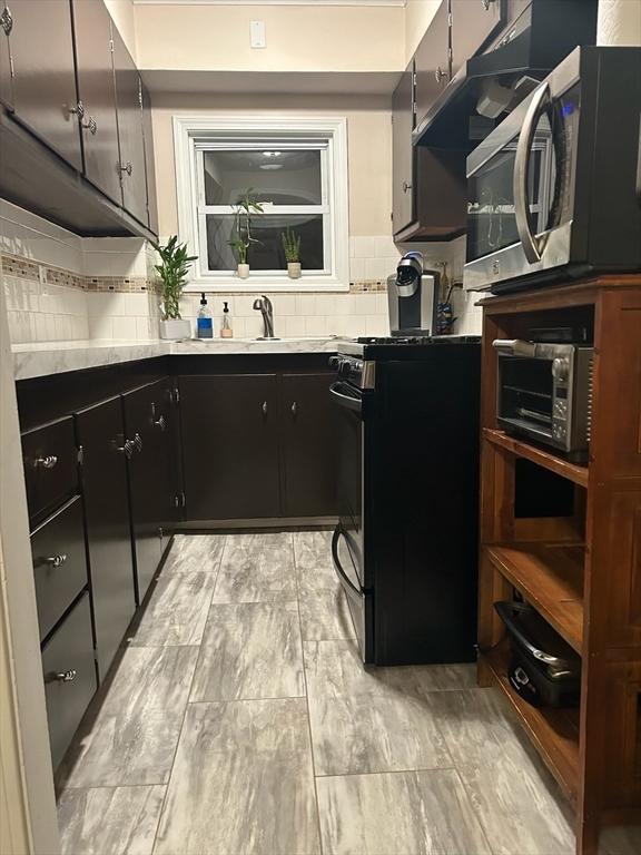 166 Bradford Avenue Fall River, MA 02721 - Photo 6 of 28 a kitchen with a sink and cabinets