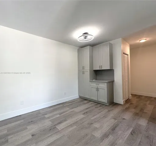 a view of kitchen with a sink cabinets and wooden floor