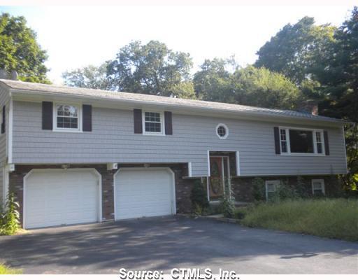61 Ash Road Naugatuck, CT 06770 - Photo 1 of 1 a front view of a house with a yard and garage