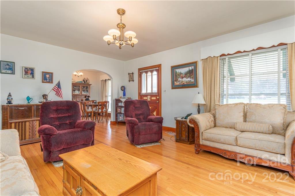 4189 Old Clyde Road Clyde, NC 28721 - Photo 3 of 27 a living room with furniture and a chandelier