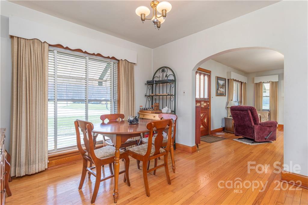 4189 Old Clyde Road Clyde, NC 28721 - Photo 4 of 27 a view of a dining room with furniture window and wooden floor