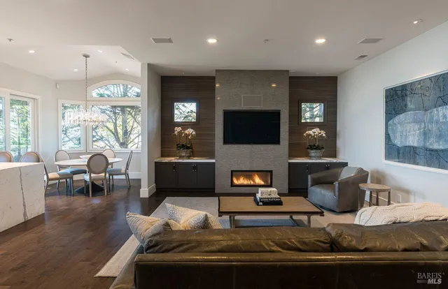 a bedroom with a bed a couch and large window