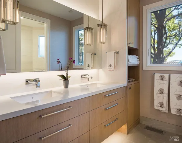 a bedroom with two beds and a chandelier