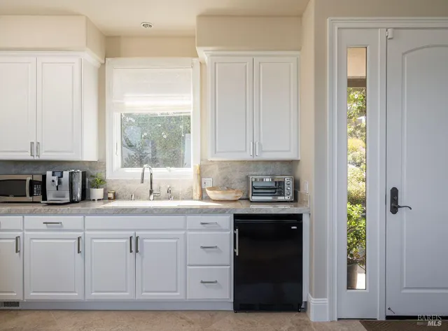 a view of a balcony with chairs and wooden floor