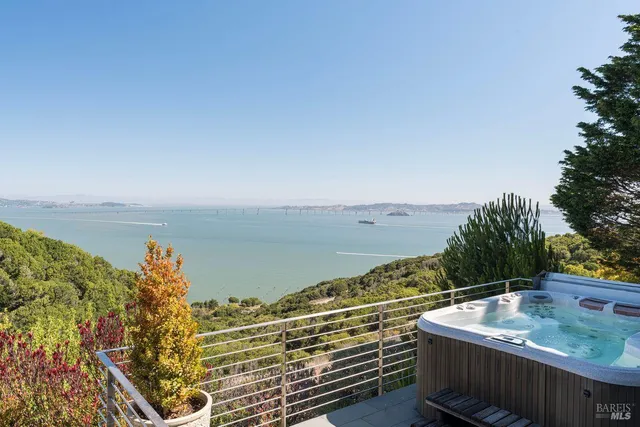 a living room with furniture fireplace and floor to ceiling windows