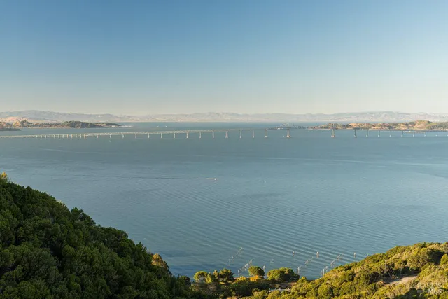 a view of a mountain with a yard