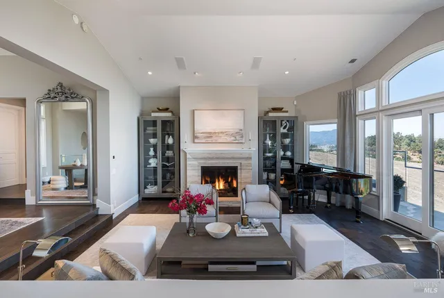 a dining room with furniture a chandelier and wooden floor