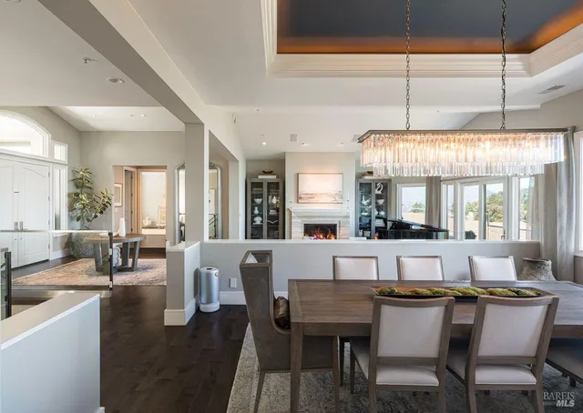 a kitchen that has a lot of white cabinets and stainless steel appliances