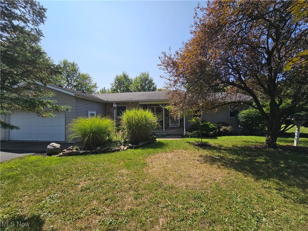 24192 Quarry Road Wellington, OH 44090 - Photo 1 of 28 Single story home with a garage and a front yard