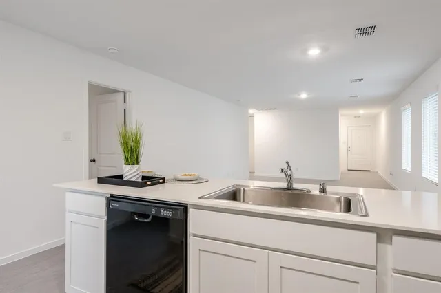 a kitchen with a sink and cabinets