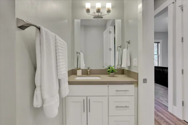a bathroom with a double vanity sink and mirror