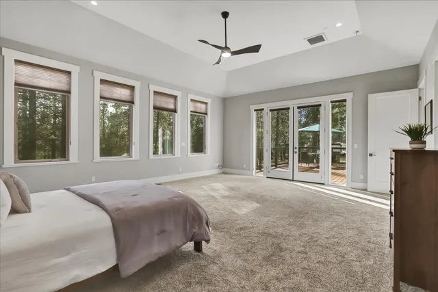 a spacious bedroom with a large bed and a large window