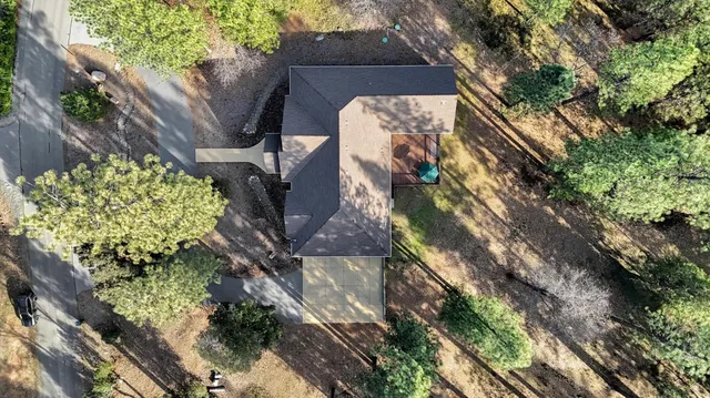 a front view of a house with a yard covered in snow