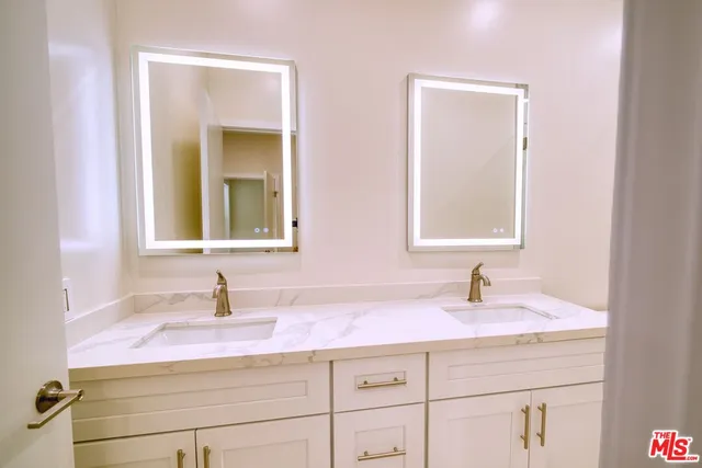 a bathroom with sink and mirror
