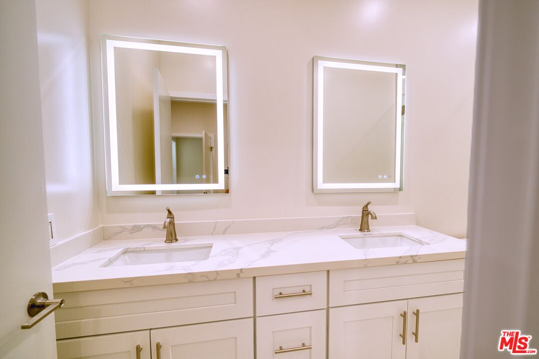 13920 Moorpark Street, Unit 201 Sherman Oaks, CA 91423 - Photo 13 of 25 a bathroom with sink and mirror