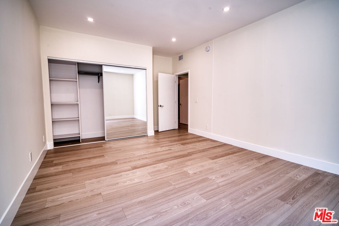 13920 Moorpark Street, Unit 201 Sherman Oaks, CA 91423 - Photo 14 of 25 a view of an empty room with wooden floor and closet