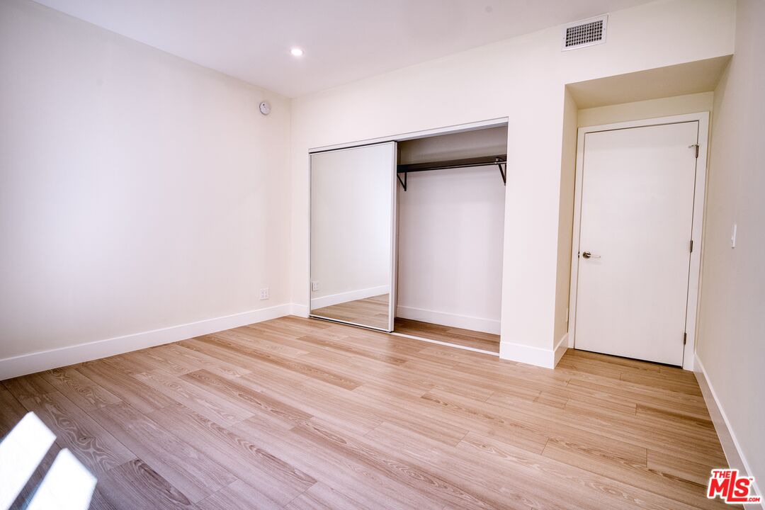 13920 Moorpark Street, Unit 201 Sherman Oaks, CA 91423 - Photo 17 of 25 a view of an empty room with wooden floor and closet