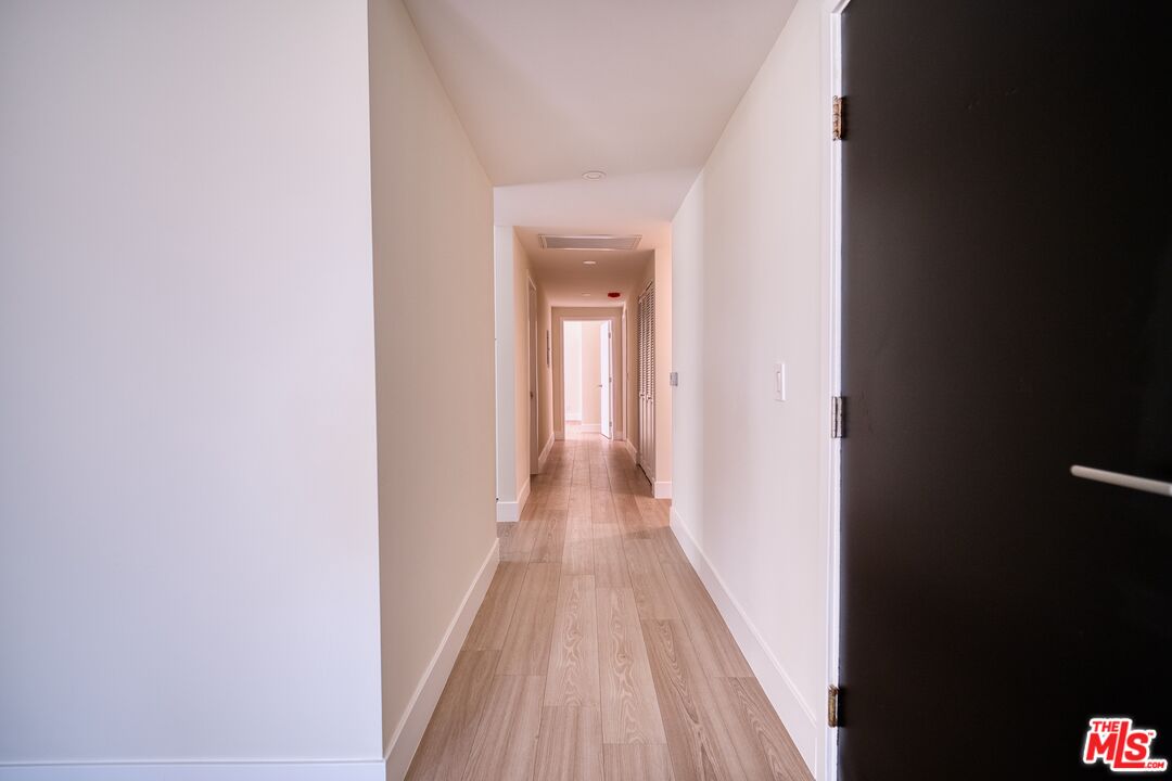 13920 Moorpark Street, Unit 201 Sherman Oaks, CA 91423 - Photo 19 of 25 a view of a hallway with wooden floor