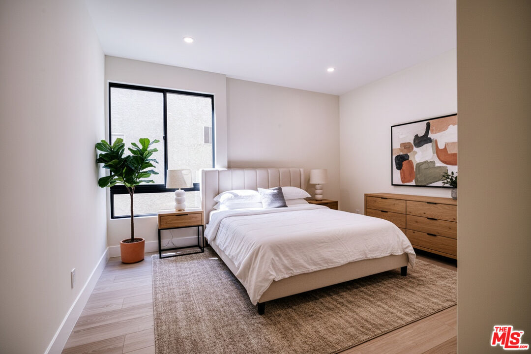 13920 Moorpark Street, Unit 201 Sherman Oaks, CA 91423 - Photo 2 of 25 a bedroom with a bed and a potted plant