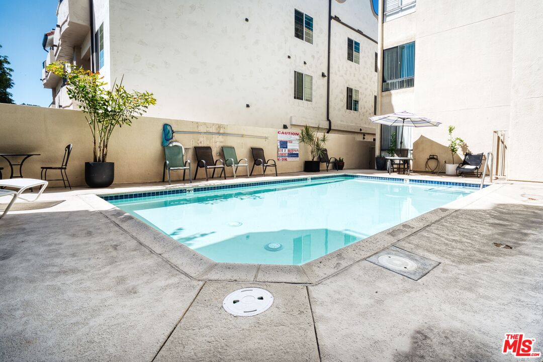 13920 Moorpark Street, Unit 201 Sherman Oaks, CA 91423 - Photo 23 of 25 a view of a swimming pool with furniture