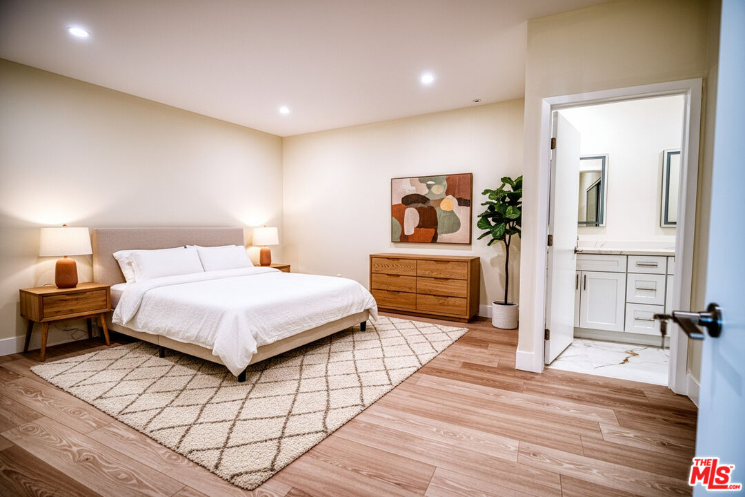 13920 Moorpark Street, Unit 201 Sherman Oaks, CA 91423 - Photo 3 of 25 a spacious bedroom with a bed and a view of bathroom