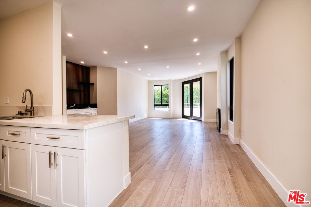 13920 Moorpark Street, Unit 201 Sherman Oaks, CA 91423 - Photo 7 of 25 a kitchen with a sink and wooden floor