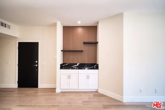 a view of a kitchen with a sink and cabinets