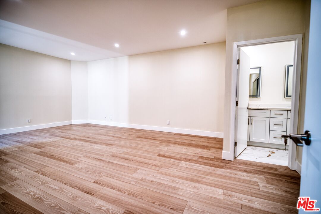 13920 Moorpark Street, Unit 201 Sherman Oaks, CA 91423 - Photo 10 of 25 a view of empty room with wooden floor and fireplace