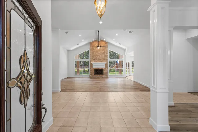a view of empty room with wooden floor and fireplace