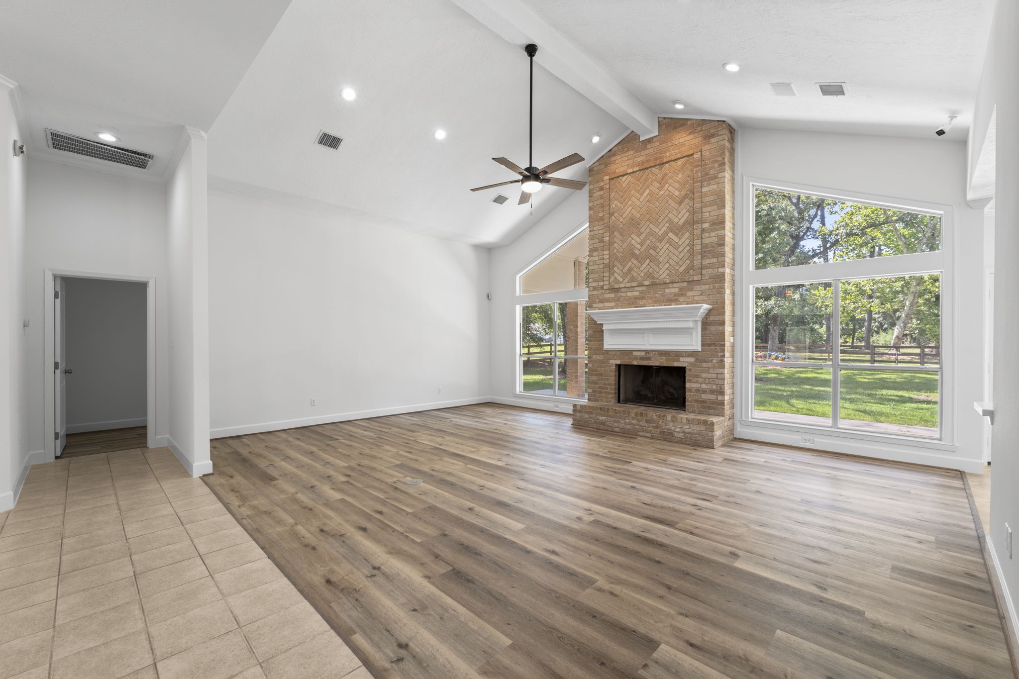 15456 Pin Oak Drive Conroe, TX 77384 - Photo 13 of 44 a view of empty room with wooden floor and fireplace