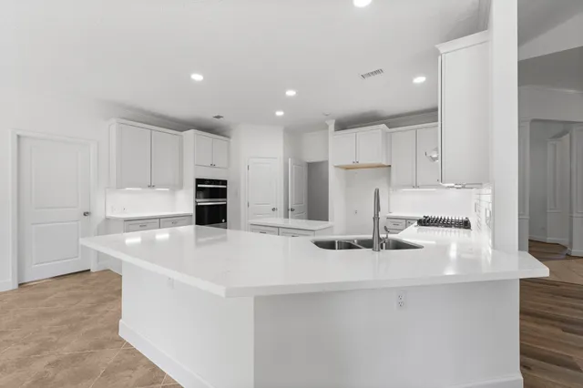 a kitchen with white cabinets and white appliances