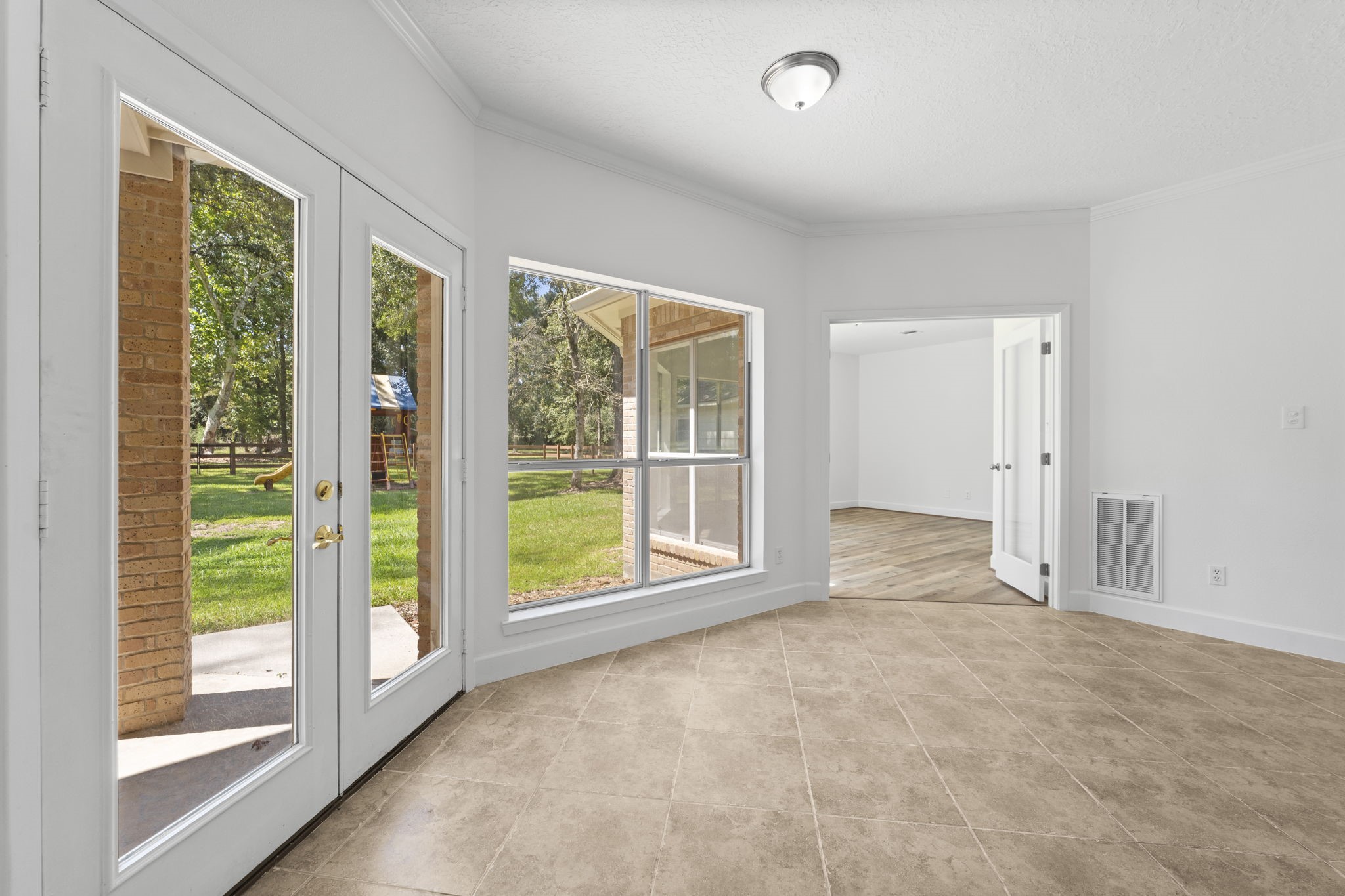 15456 Pin Oak Drive Conroe, TX 77384 - Photo 19 of 44 a view of an empty room with a fireplace and a large window