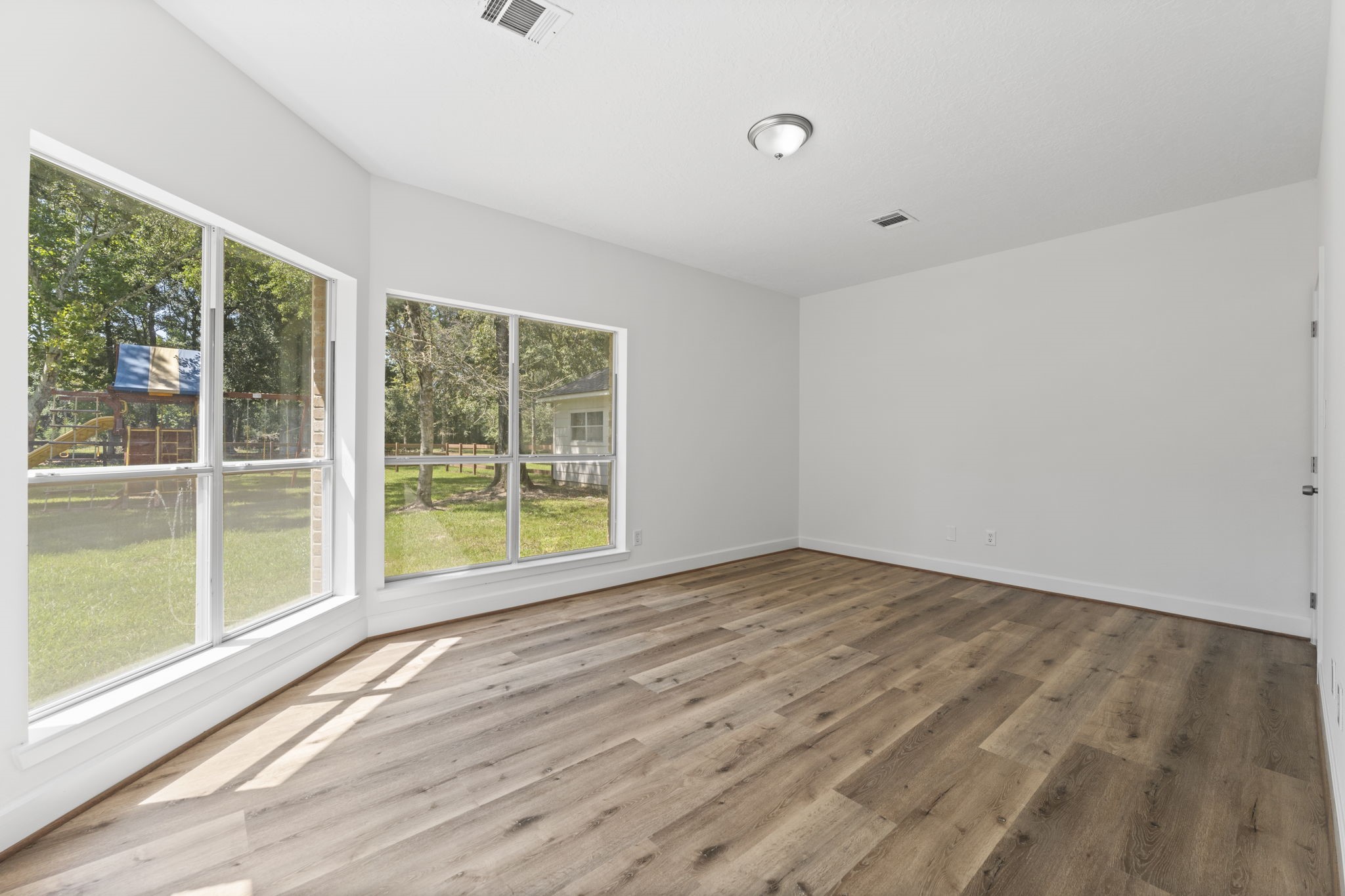 15456 Pin Oak Drive Conroe, TX 77384 - Photo 20 of 44 a view of empty room with wooden floor and fan