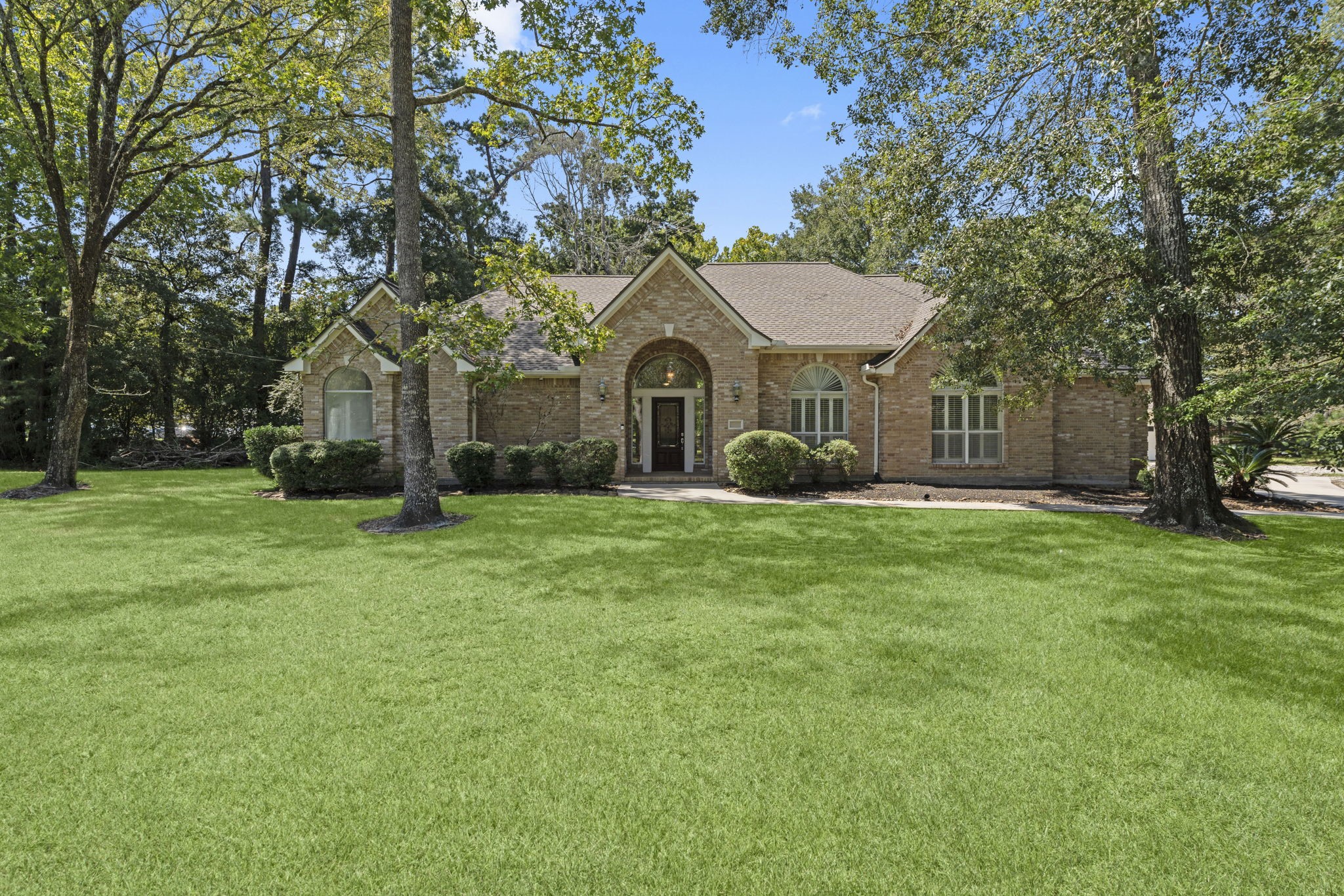 15456 Pin Oak Drive Conroe, TX 77384 - Photo 2 of 44 a front view of a house with garden