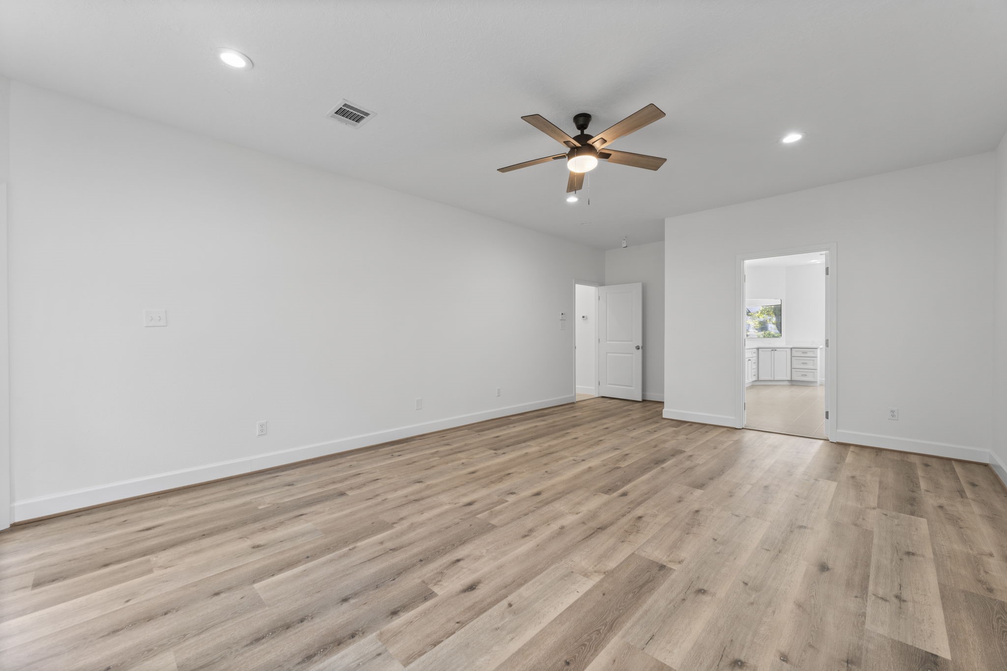 15456 Pin Oak Drive Conroe, TX 77384 - Photo 24 of 44 a view of empty room with wooden floor and fan