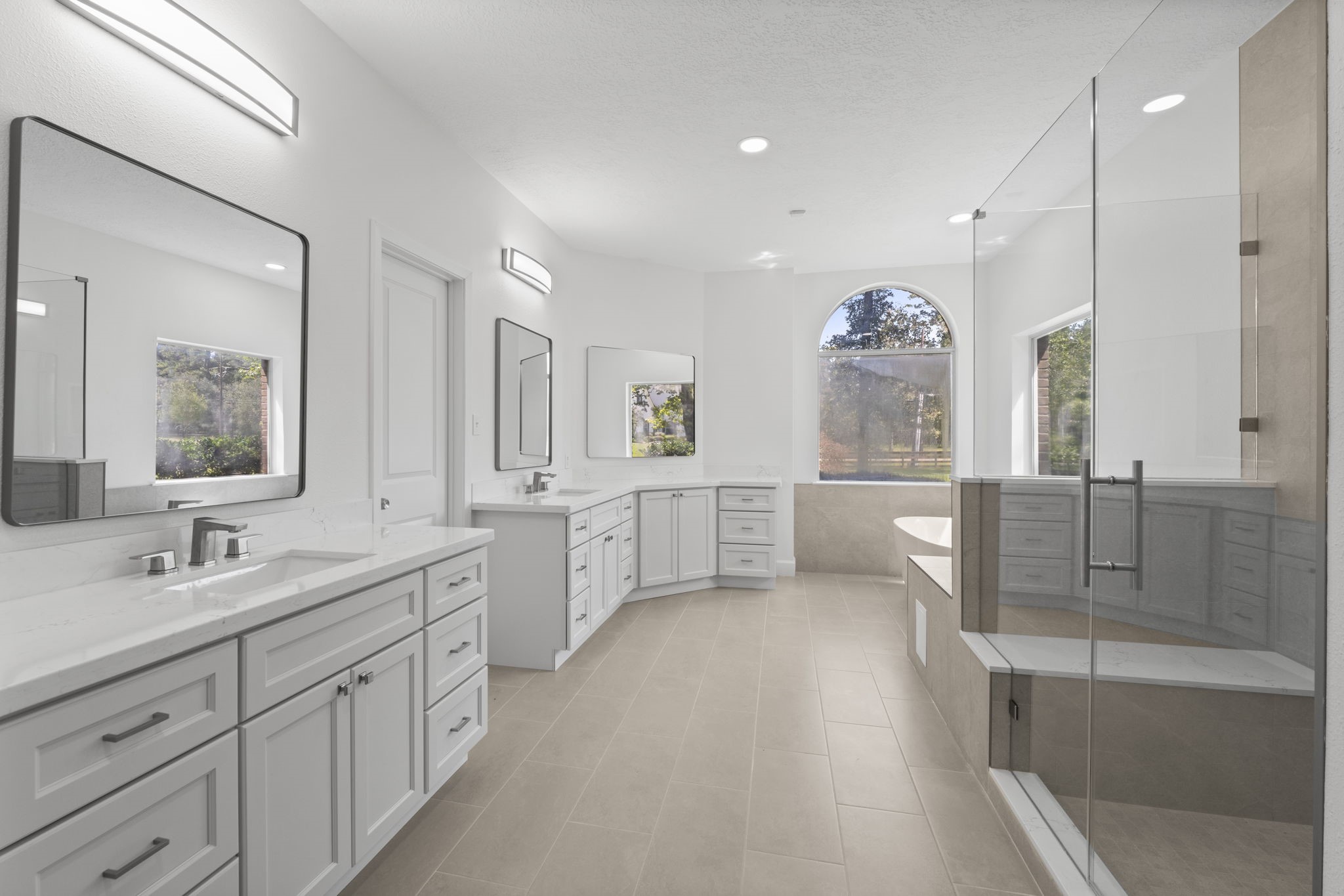 15456 Pin Oak Drive Conroe, TX 77384 - Photo 25 of 44 a spacious bathroom with double vanity a mirror a bathtub and a shower