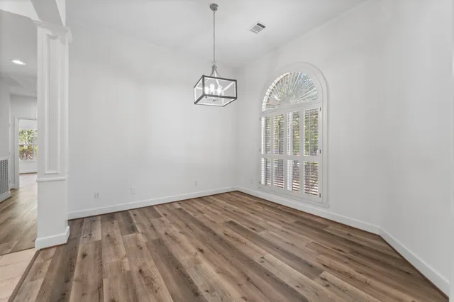 wooden floor in an empty room with a window
