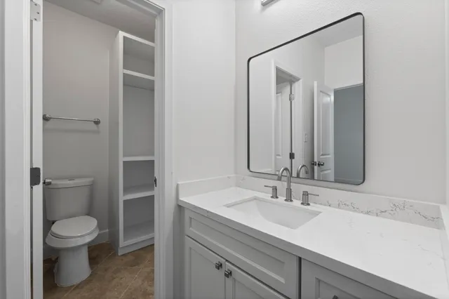 an empty room with wooden floor ceiling fan and windows