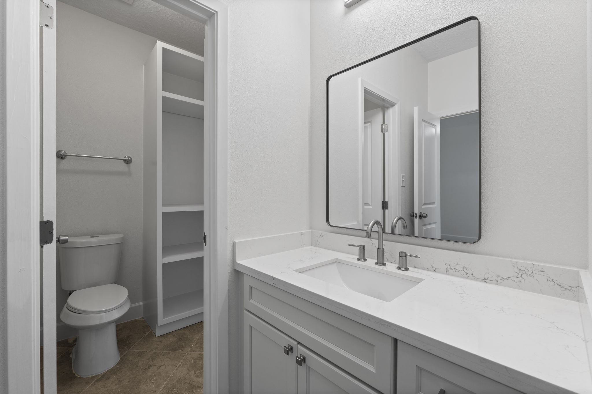 15456 Pin Oak Drive Conroe, TX 77384 - Photo 32 of 44 a bathroom with a toilet a sink and mirror