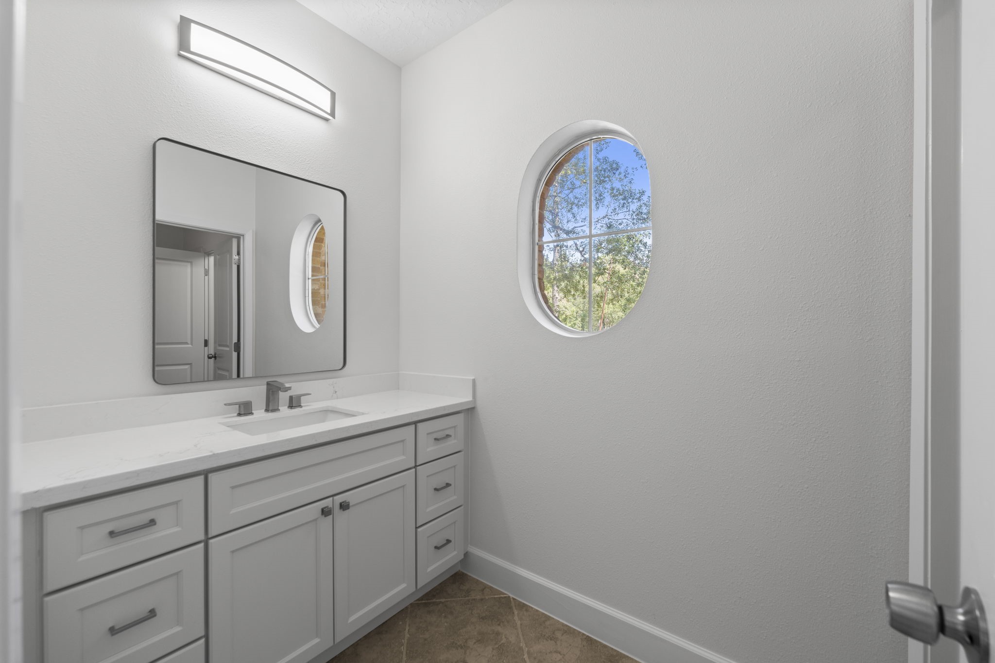 15456 Pin Oak Drive Conroe, TX 77384 - Photo 35 of 44 a bathroom with a toilet sink and mirror