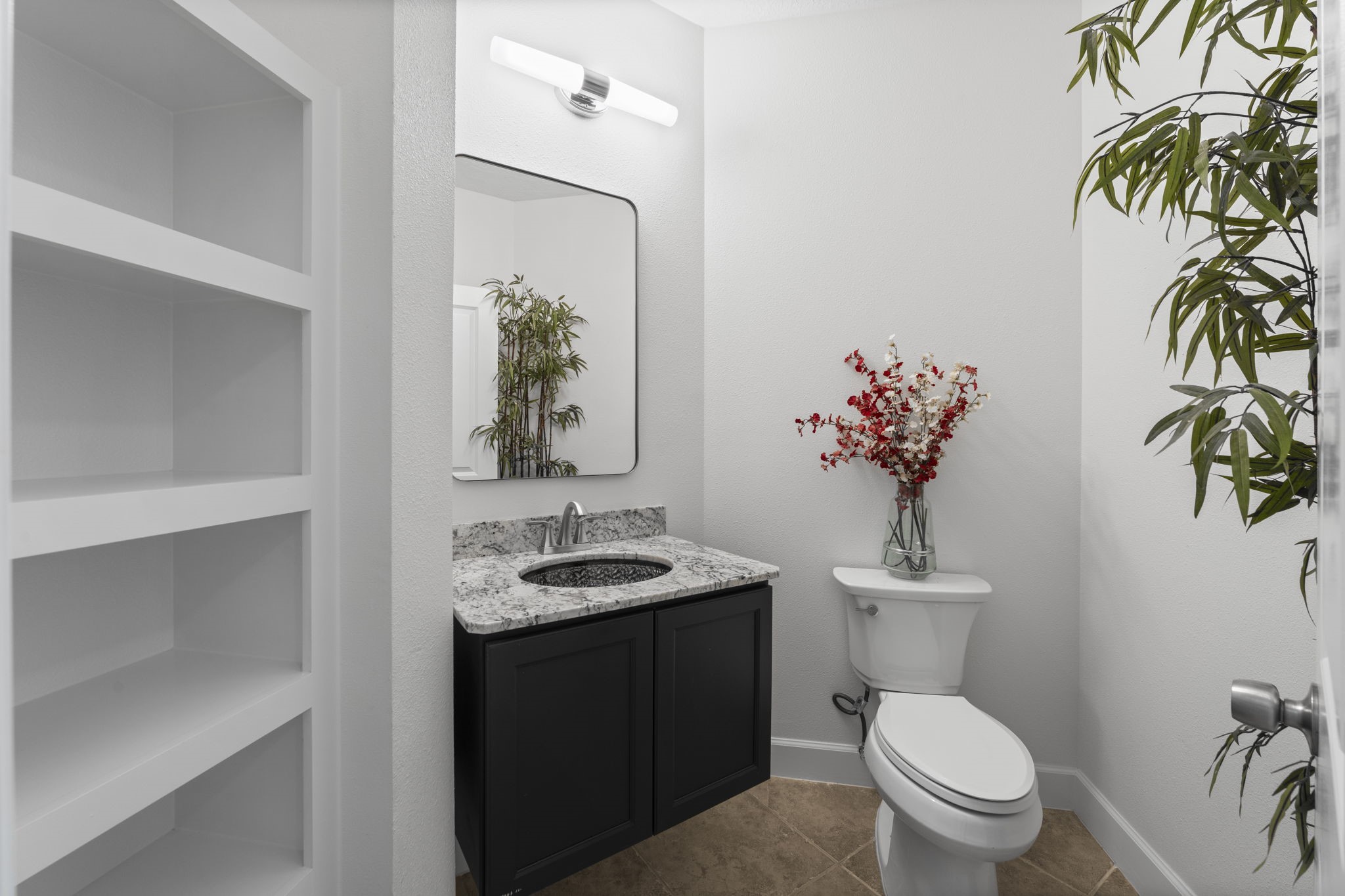 15456 Pin Oak Drive Conroe, TX 77384 - Photo 37 of 44 a bathroom with a toilet sink and mirror