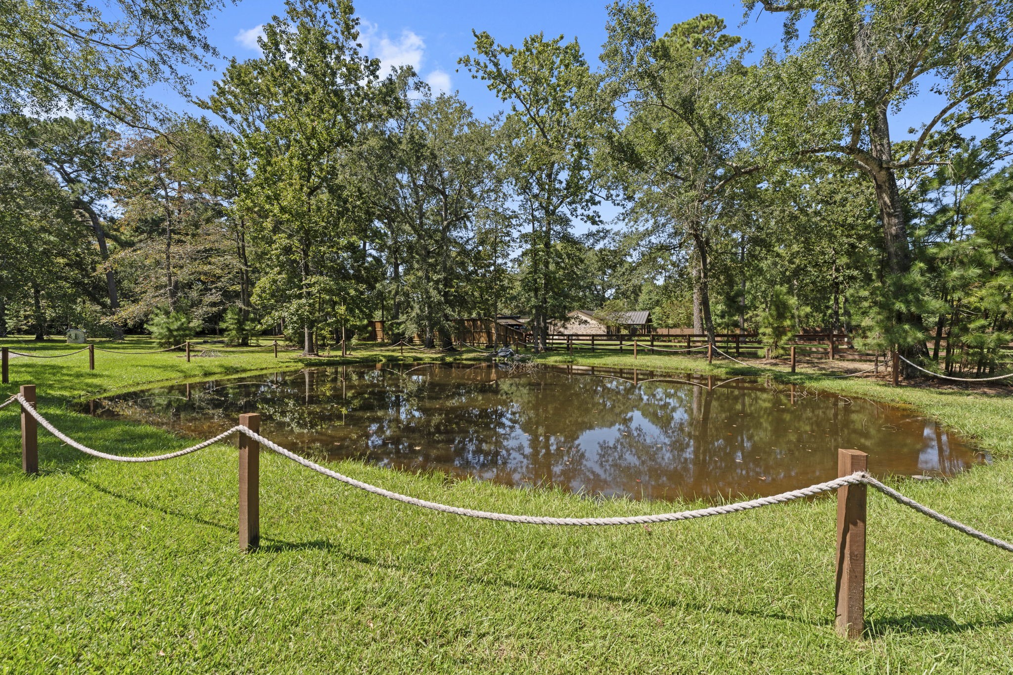 15456 Pin Oak Drive Conroe, TX 77384 - Photo 39 of 44 a view of a lake with a house